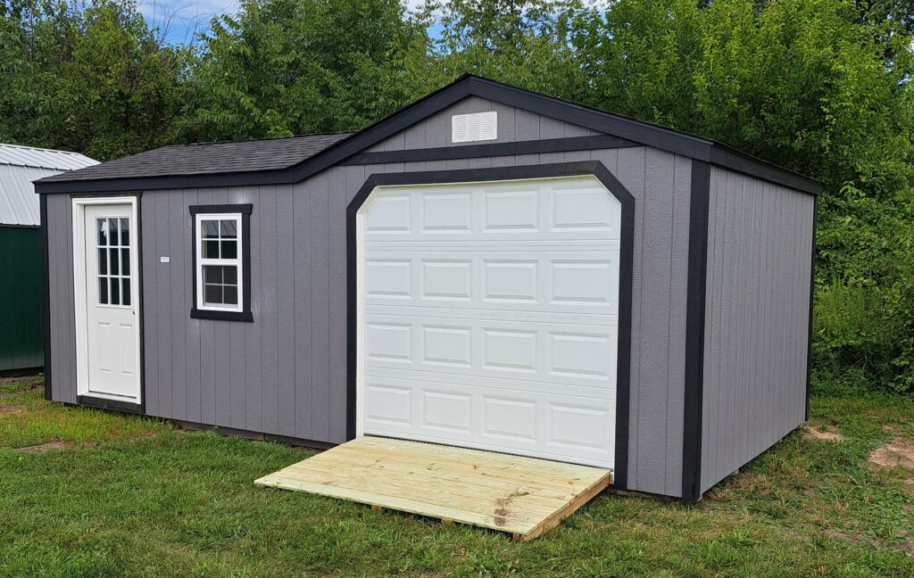 12x24 garage shed combo with gray siding, black trim, white doors, and ramp