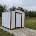 8x10 bargain barn with white metal siding and red trim