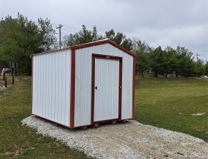 8x10 bargain barn with white metal siding and red trim