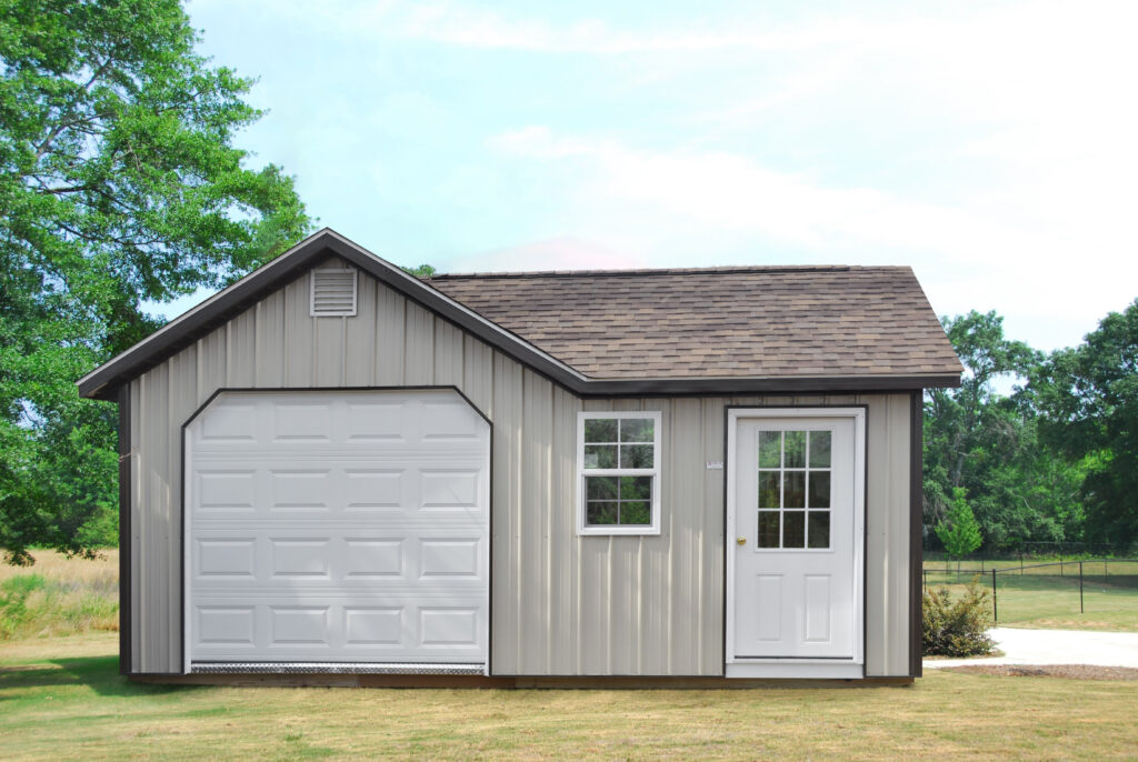 garage shed with tan siding, brown roof, and white doors
