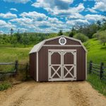 lofted gambrel shed with brown siding and octagon window