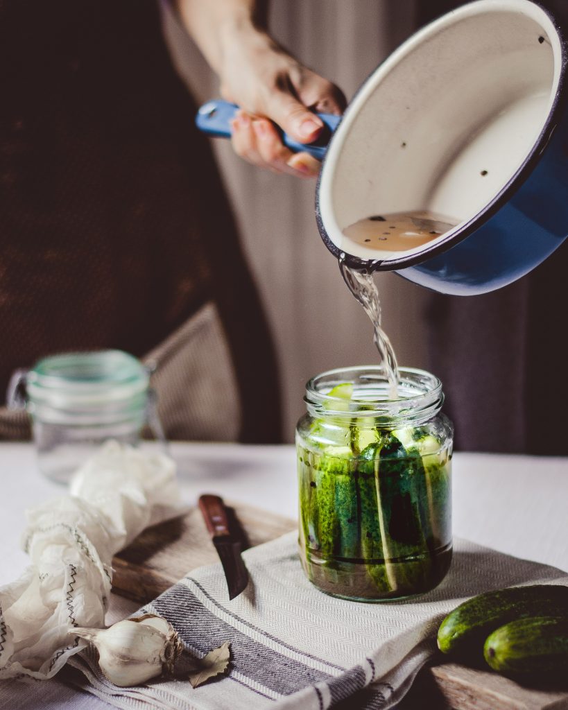 Close up of a person canning vegetables