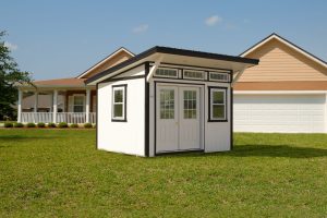 Classic Studio Shed with white siding, black trim, double doors with windows, a slanted roof, and transom windows.