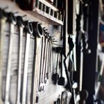 tools and lawn equipment hanging up in a storage shed