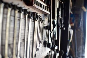 tools and lawn equipment hanging up in a storage shed