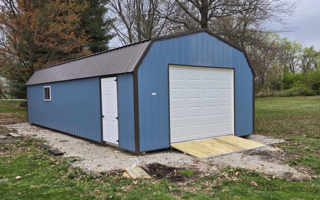 painted 16x40 lofted garage with blue siding, white doors, and ramp