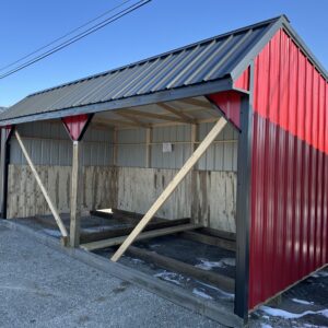 open horse barn with red siding