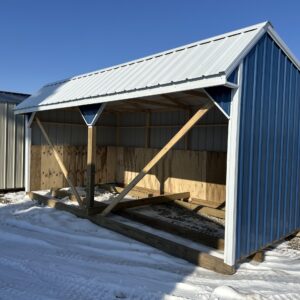 open horse barn with blue siding