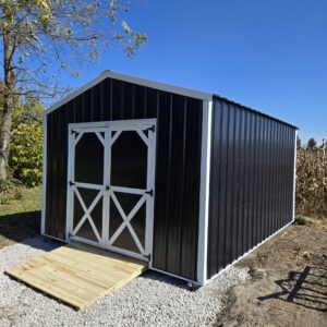 black utility shed with white trim