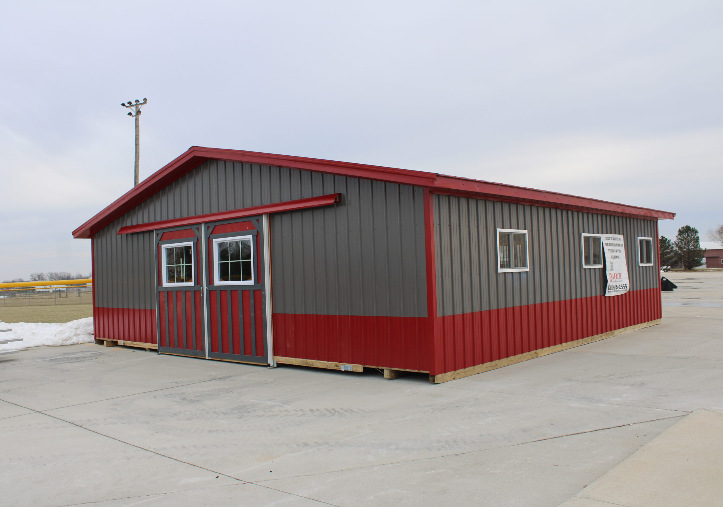 heritage horse barn with gray and red metal siding