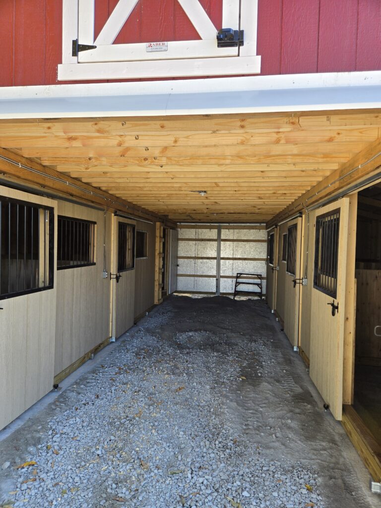 breezeway in a red monitor horse barn