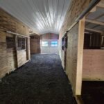 aisle and stalls in heritage horse barn
