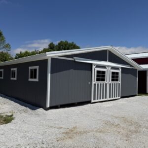 exterior of a heritage horse barn with dark grey siding
