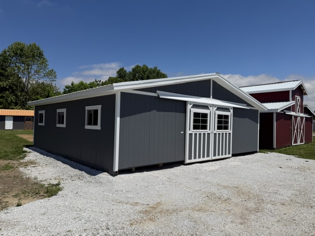 exterior of a heritage horse barn with dark grey siding