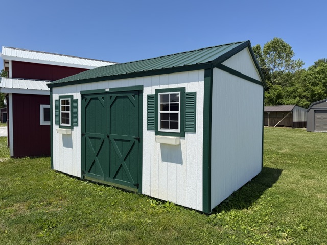 12x16 garden shed with white siding and green doors and trim