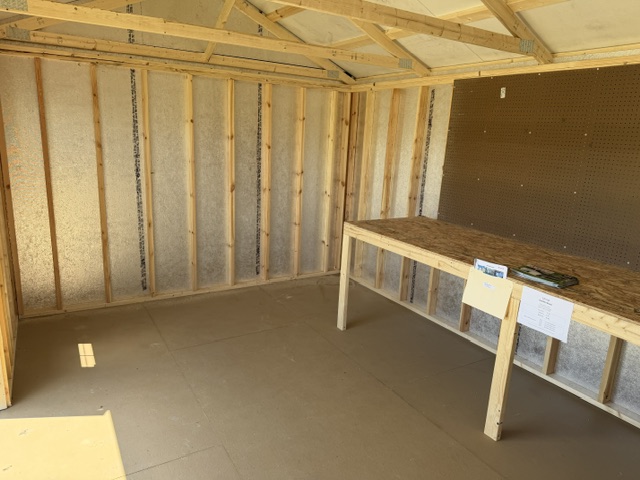 interior of 12x16 garden shed with workbench and pegboard