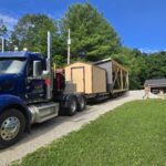 delivery truck with bargain barn and half of a two car garage