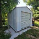 metal utility shed with white siding