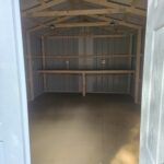 interior of metal utility shed with built in shelf