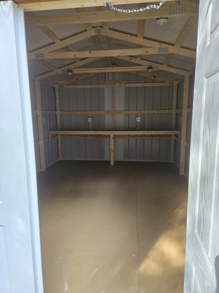 interior of metal utility shed with built in shelf