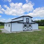 white montior horse barn with black trim